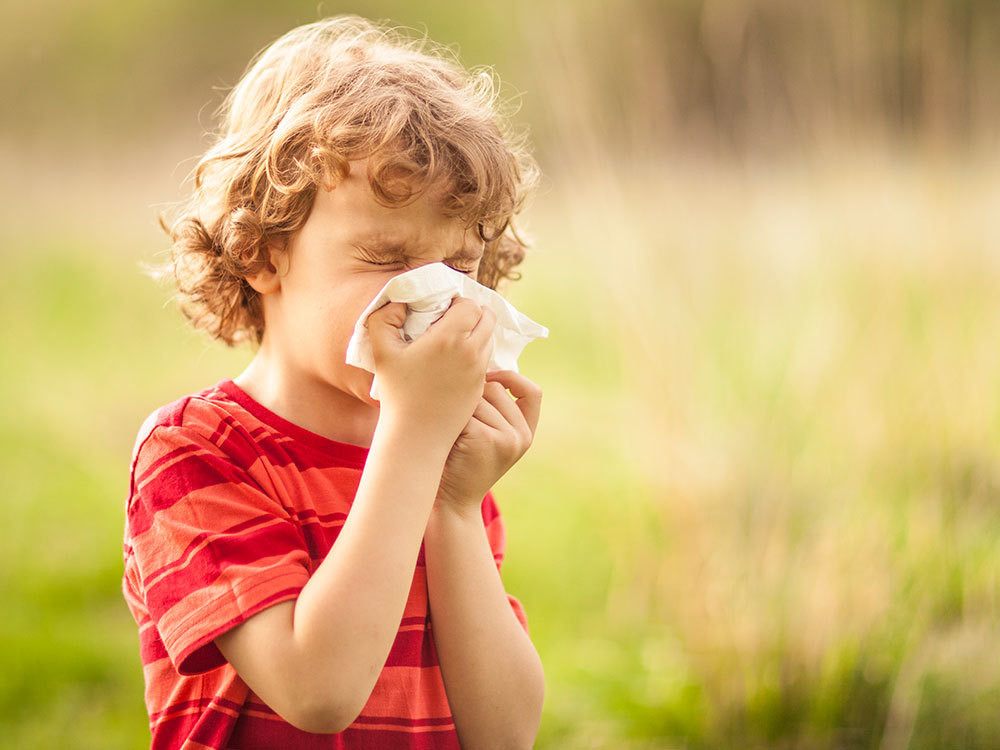 A child blowing their nose.