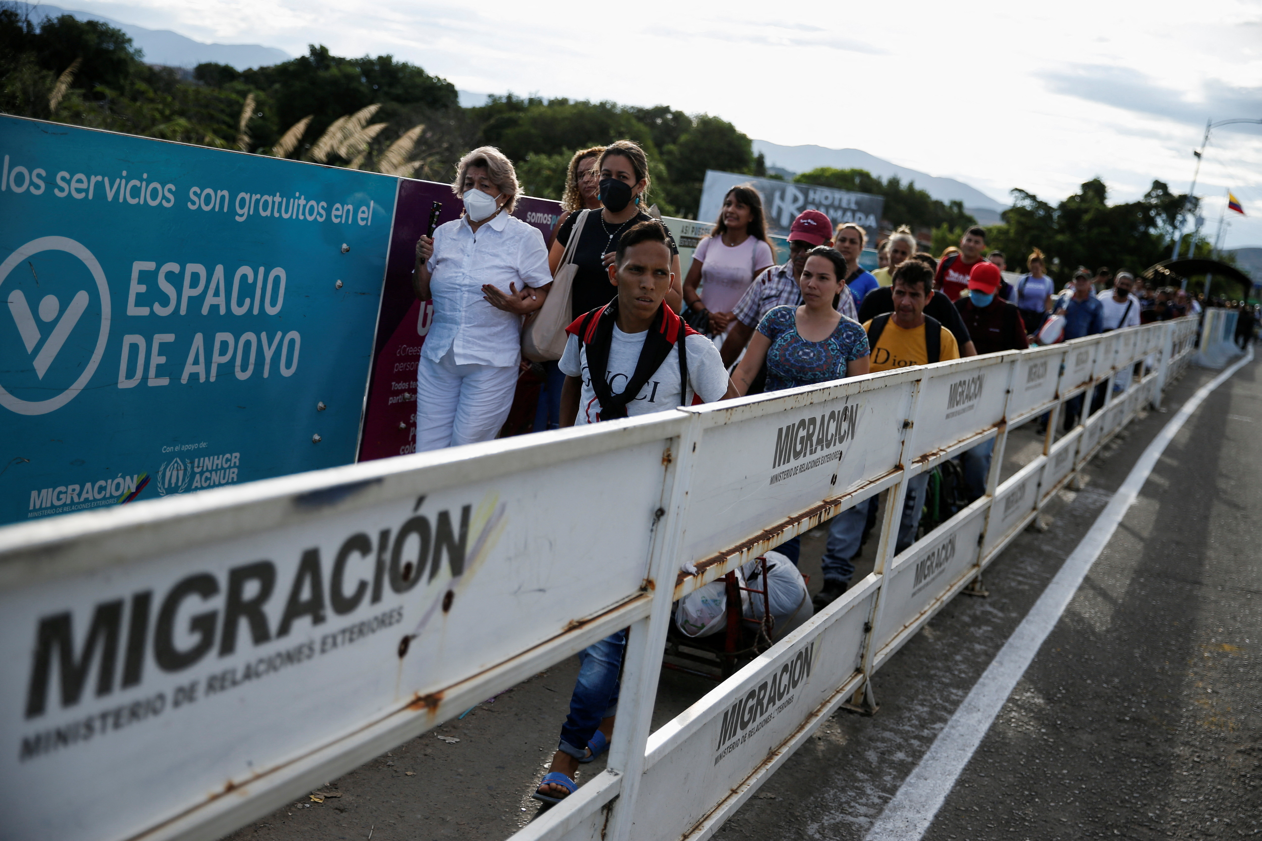 Venezuelans walk over the Simon Bolivar International Bridge, the border between Colombia and Venezuela  - migration